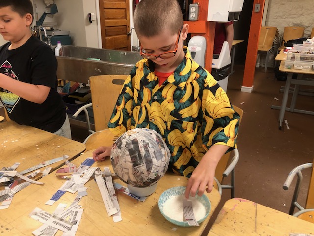 boy doing paper mache