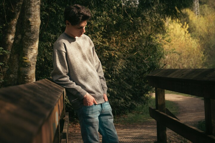 teen boy with hands in pockets thinking outside